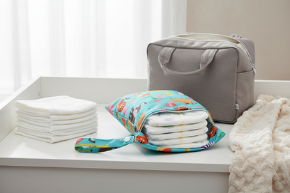 CubPouch animal-print baby wet bag on a nursery changing table